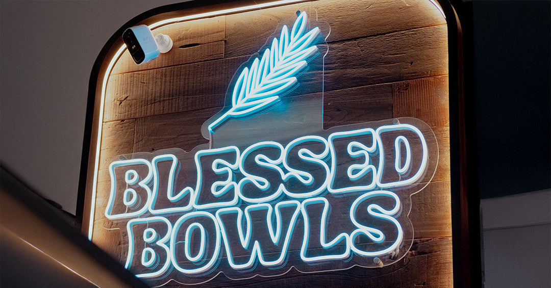 Blessed Bowls custom neon logo on a reclaimed timber café wall